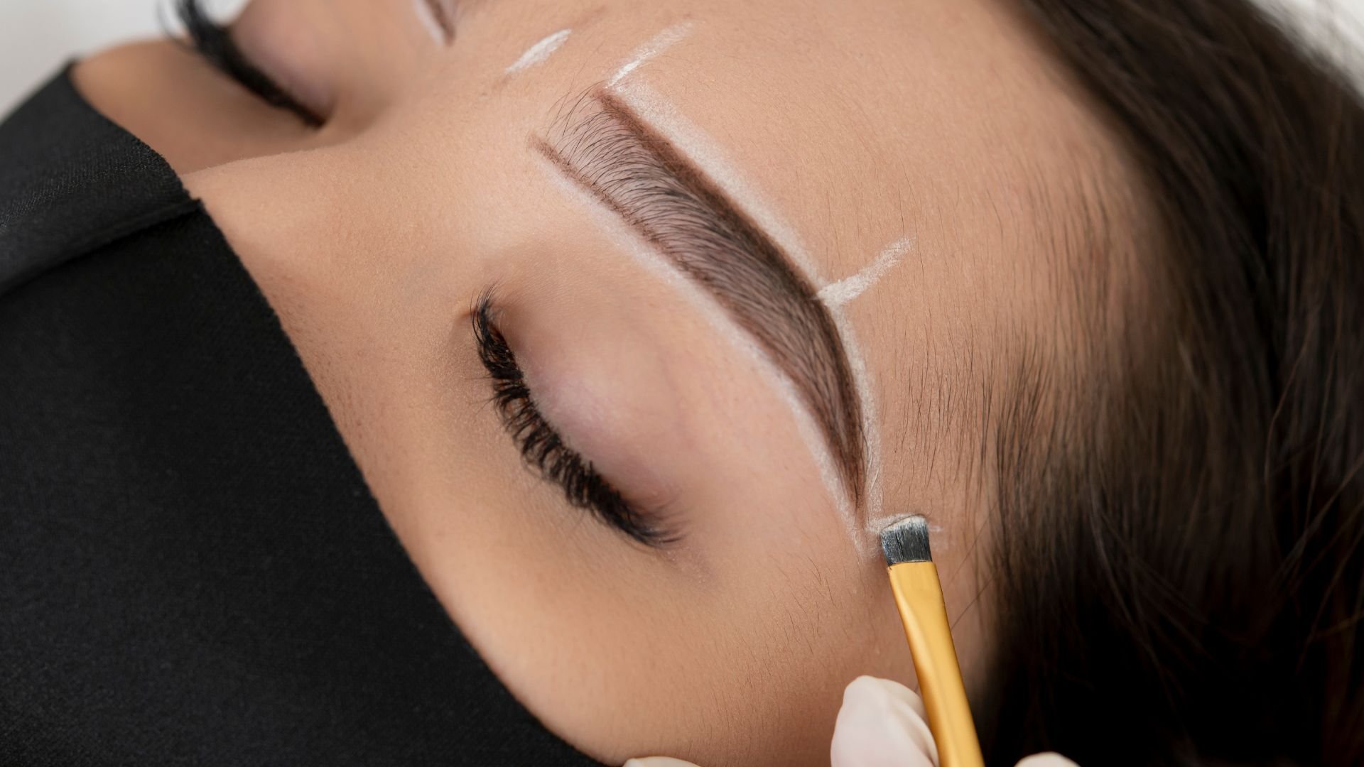 Close-up of microblading procedure for perfect eyebrow shaping and filling